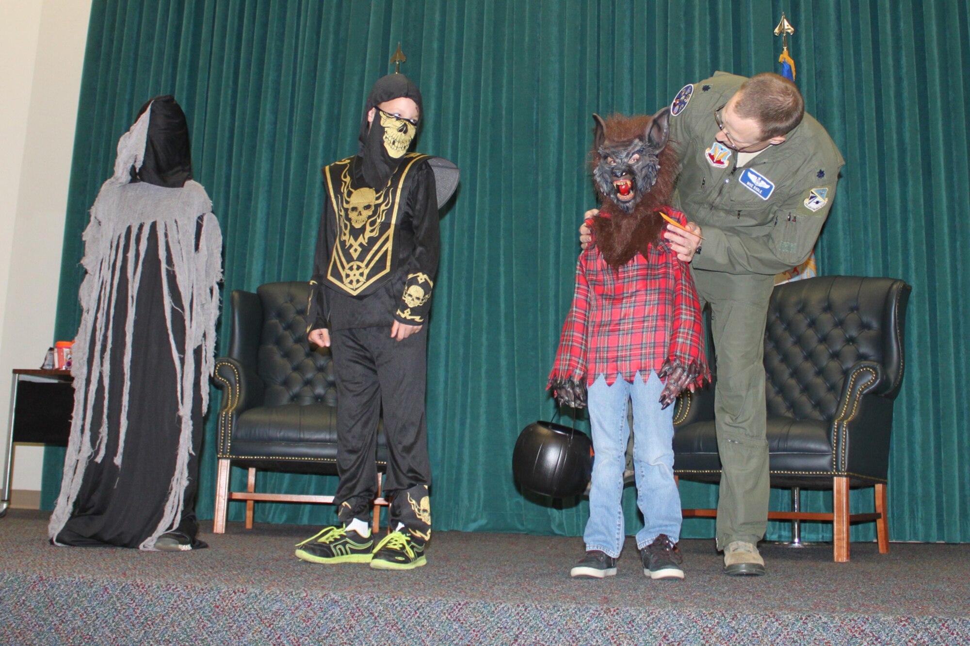 Lt. Col. Mike Radle, deputy commander of the 552nd Operations Group, speaks to the winner of the “Scary Boy” costume contest in Fannin Hall. The contest was part of the wing’s Boo Bash, a fall festival with trick or treating, food and an opportunity for all families, including families of the wing’s nearly 600 deployed members, to gather and celebrate. (Air Force photo by Karla Bickley)