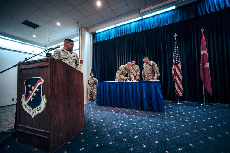 Staff Sgt. Alexandra Woodlee, 39th Security Forces Squadron military working dog handler, signs adoption papers for Kira, 39th SFS MWD Oct. 27, 2014, Incirlik Air Base, Turkey.  Woodlee will be taking Kira with her on her upcoming permanent change of station to Ramstein Air Base, Germany.  (U.S. Air Force photo by Senior Airman Nicole Sikorski/Released)