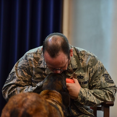 Tech. Sgt. Kenneth Fresquez, 39th Security Forces Squadron kennel master, kisses Kira, 39th SFS military working dog, during her retirement ceremony Oct. 27, 2014, Incirlik Air Base, Turkey.  Kira has been a U.S. Air Force MWD for 10 years, eight years at Incirlik AB, working as a narcotic K-9. (U.S. Air Force photo by Senior Airman Nicole Sikorski/Released) 