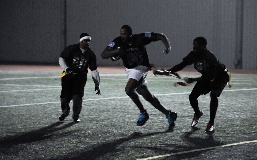 Victor Calcote, 51st Force Support Squadron, gets his flag pulled after gaining 15-yards during an intramural flag football game against the 7th Air Force team Oct. 29, 2014, on Osan Air Base, Republic of Korea. FSS scored on the drive putting them up 13-6 in the first half. (U.S. Air Force photo by Senior Airman David Owsianka)