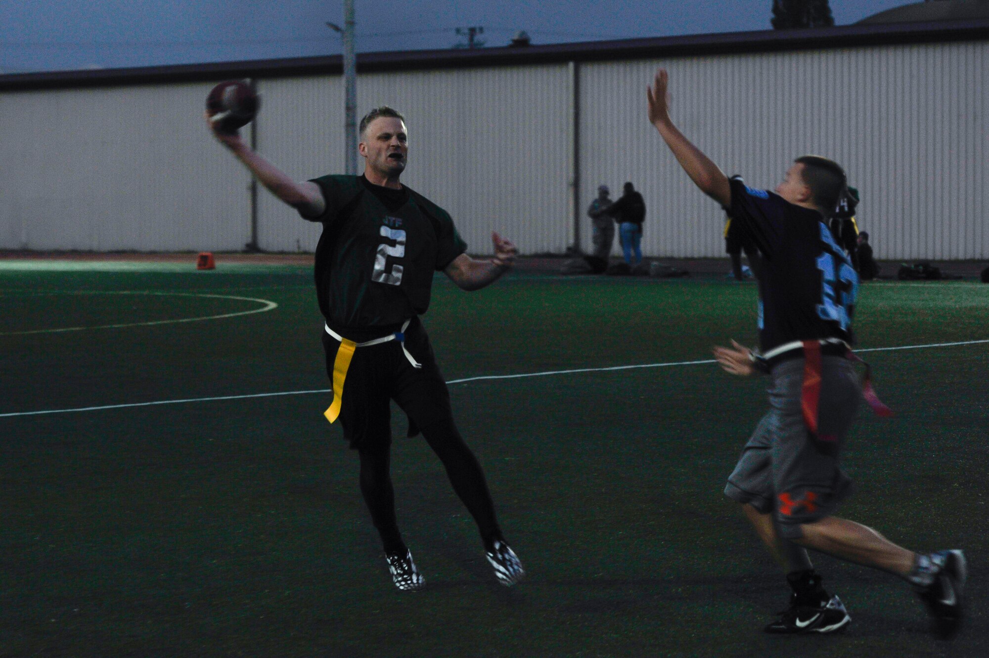 Andrew Entz, 7th Air Force, makes a pass on the first play during an intramural flag football game against the 51st Force Support Squadron team Oct. 29, 2014, on Osan Air Base, Republic of Korea. Entz completed the pass for a 10-yard gain. (U.S. Air Force photo by Senior Airman David Owsianka)