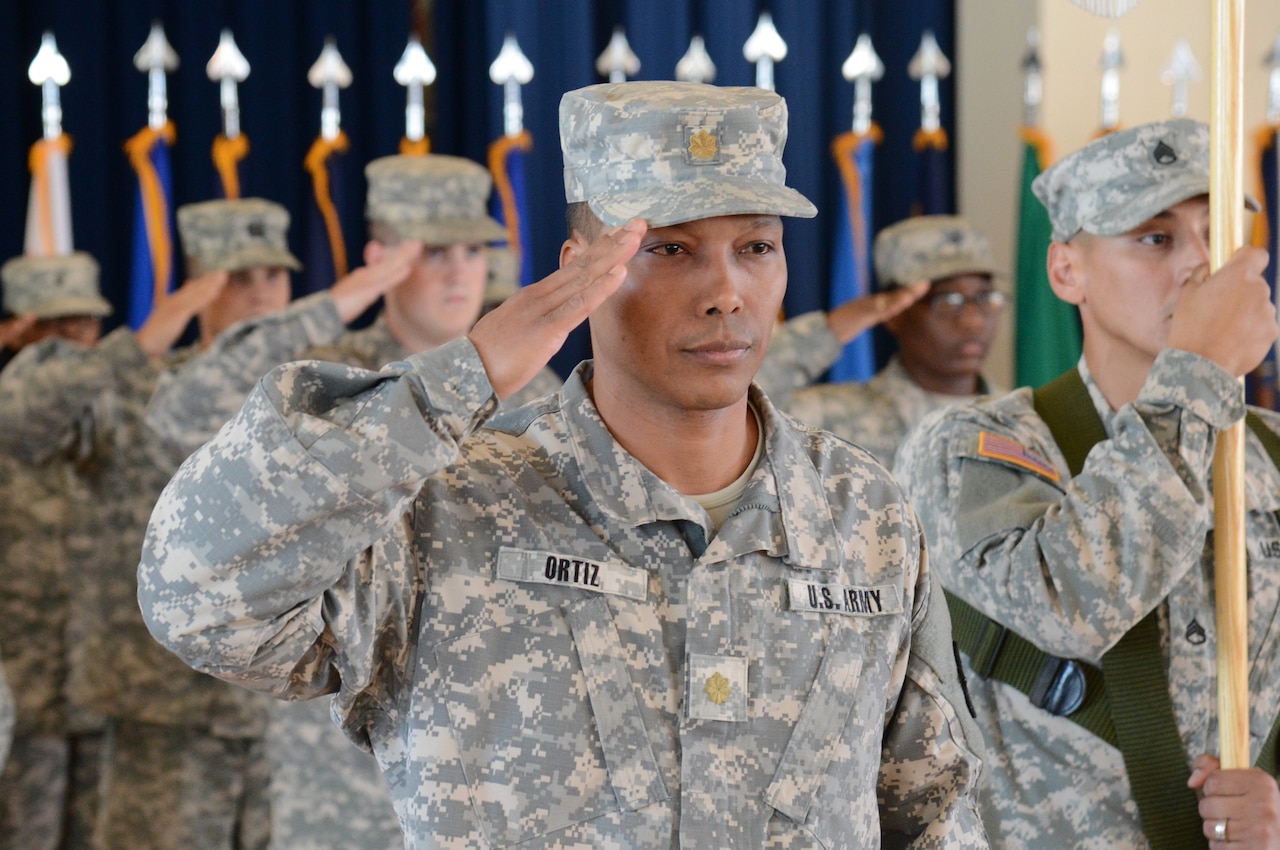 Army Maj. Felix Ortiz, executive officer of the 1st Area Medical Laboratory, salutes during the 1st AML's Oct. 27, 2014, casing ceremony at Aberdeen Proving Ground, Md. The AML is deploying to Liberia to set up laboratories in support of Operation United Assistance, the U.S. response to the Ebola outbreak in West Africa. U.S. Army photo by Sean Kief