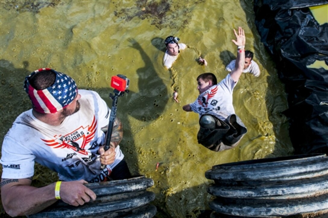 Marine veteran Lance Cpl. Erik Galvin leaps from an obstacle during a Tough Mudder competition in Temecula, Calif., Oct. 25. The event, which occurs at various locations around the United States, is a military-style obstacle course focusing on endurance and teamwork. 