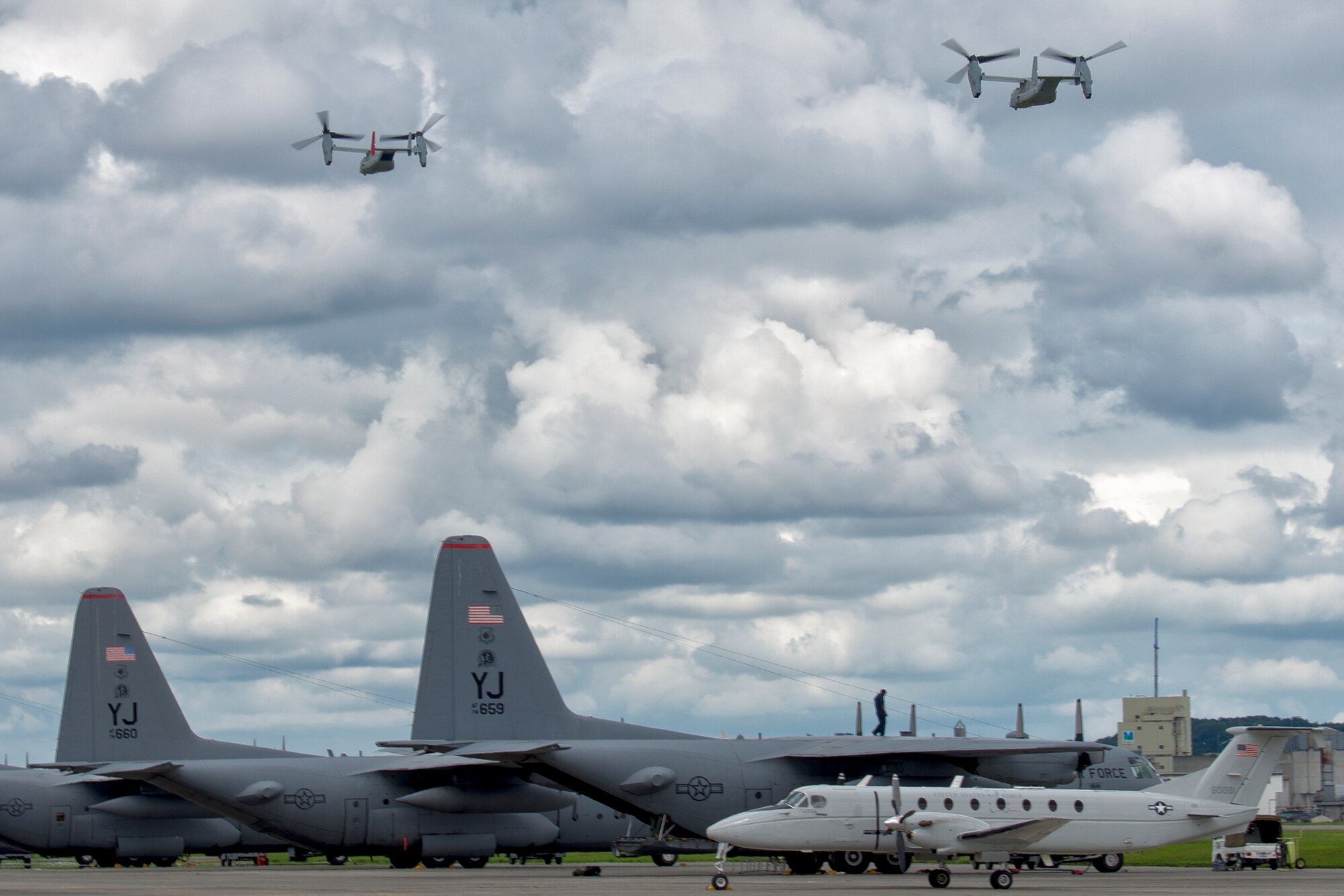 Two MV-22 Osprey assigned to VMM-265, 1st Marine Aircraft Wing, 3rd Marine Expeditionary Force, take off carrying relief supplies during a joint humanitarian aid/disaster relief exercise at Yokota Air Base, Japan, Aug. 31, 2014. The aircraft displayed its range and speed by traveling round trip from Yokota to Oshima Island in approximately one hour. Airmen and Marines conducted the exercise to increase joint interoperability and exercise crisis response capabilities in the event of a natural disaster. (U.S. Air Force photo by Osakabe Yasuo/Released)