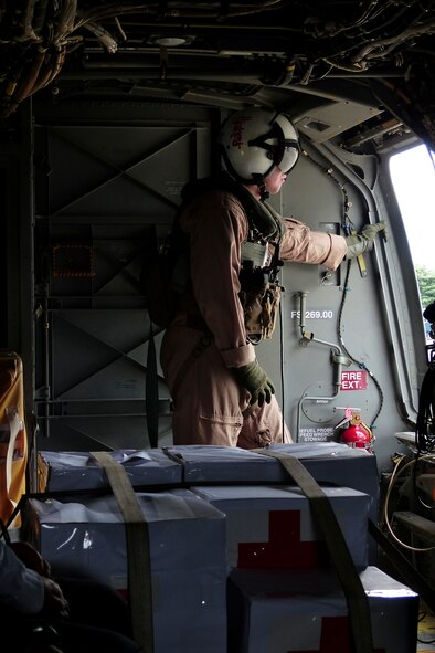 A Marine assigned to VMM-265, 1st Marine Aircraft Wing, 3rd Marine Expeditionary Force, prepares for a mission aboard an MV-22 Osprey loaded with relief supplies during a joint humanitarian aid/disaster relief exercise launched from Yokota Air Base, Japan, Aug. 31, 2014. Airmen and Marines conducted the exercise to increase joint interoperability and exercise crisis response capabilities in the event of a natural disaster. (U.S. Air Force photo by 1st Lt. Jake Bailey/Released)
