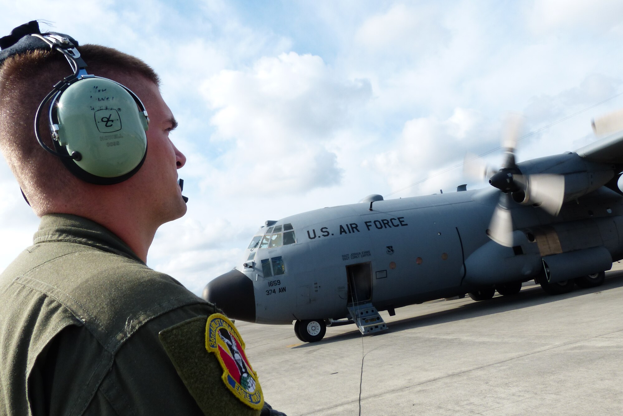 Airman 1st Class Dillon Howell, a loadmaster assigned to the 36th Airlift Squadron, monitors the engines start of a C-130H aircraft assigned to the 374th Airlift Wing at Yokota Air Base, Japan, during a bilateral disaster relief exercise supporting Shizuoka Prefecture Government Aug. 31, 2014. Airmen from the 374th Airlift Wing participated in three disaster management exercises with Japanese first responders and an additional joint exercise with Marine counterparts Aug. 30 and 31. (U.S. Air Force photo by 1st Lt. Jake Bailey/Released)