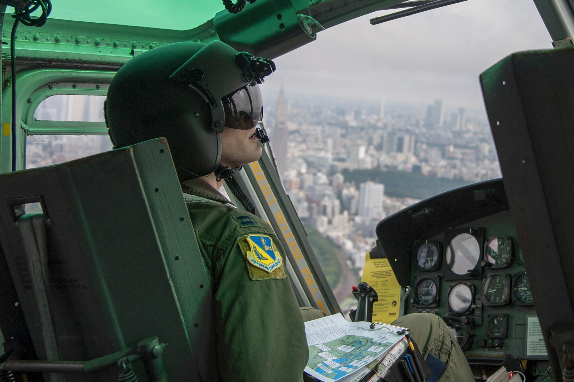 Capt. Stephen Jones, 459th Airlift Squadron UH-1N pilot, flies over Tokyo metropolitan, Aug. 30, 2014 during the Tokyo Metropolitan Government and Suginami City Joint Comprehensive Disaster Management Drill. Yokota personnel practiced delivering simulated relief supplies to Ariake no Oka core wide-area disaster prevention base in downtown Tokyo. (U.S. Air Force photo by Staff Sgt. Dustin Payne/Released)