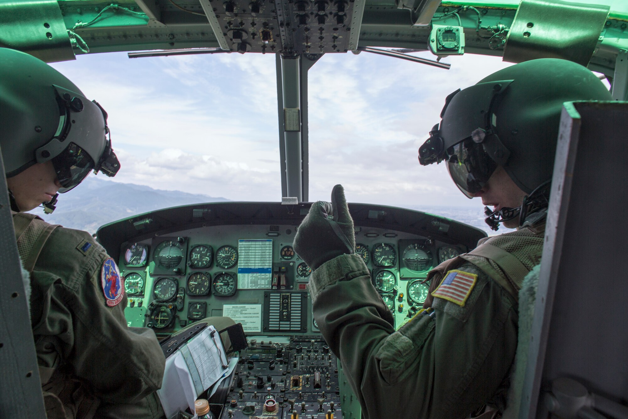 (Right to left) Capt. Doug Lincoin and 1st Lt. Daniel Trapani, both 459th Airlift Squadron UH-1N pilots, fly back to Yokota over Shizuoka prefecture, Japan, Aug. 31, 2014, after the Shizuoka Comprehensive Disaster Drill. UH-1N Iroquois crewmembers cleared a water Drop Zone for a C-130 Hercules airdrop. (U.S. Air Force photo by Osakabe Yasuo/Released) 