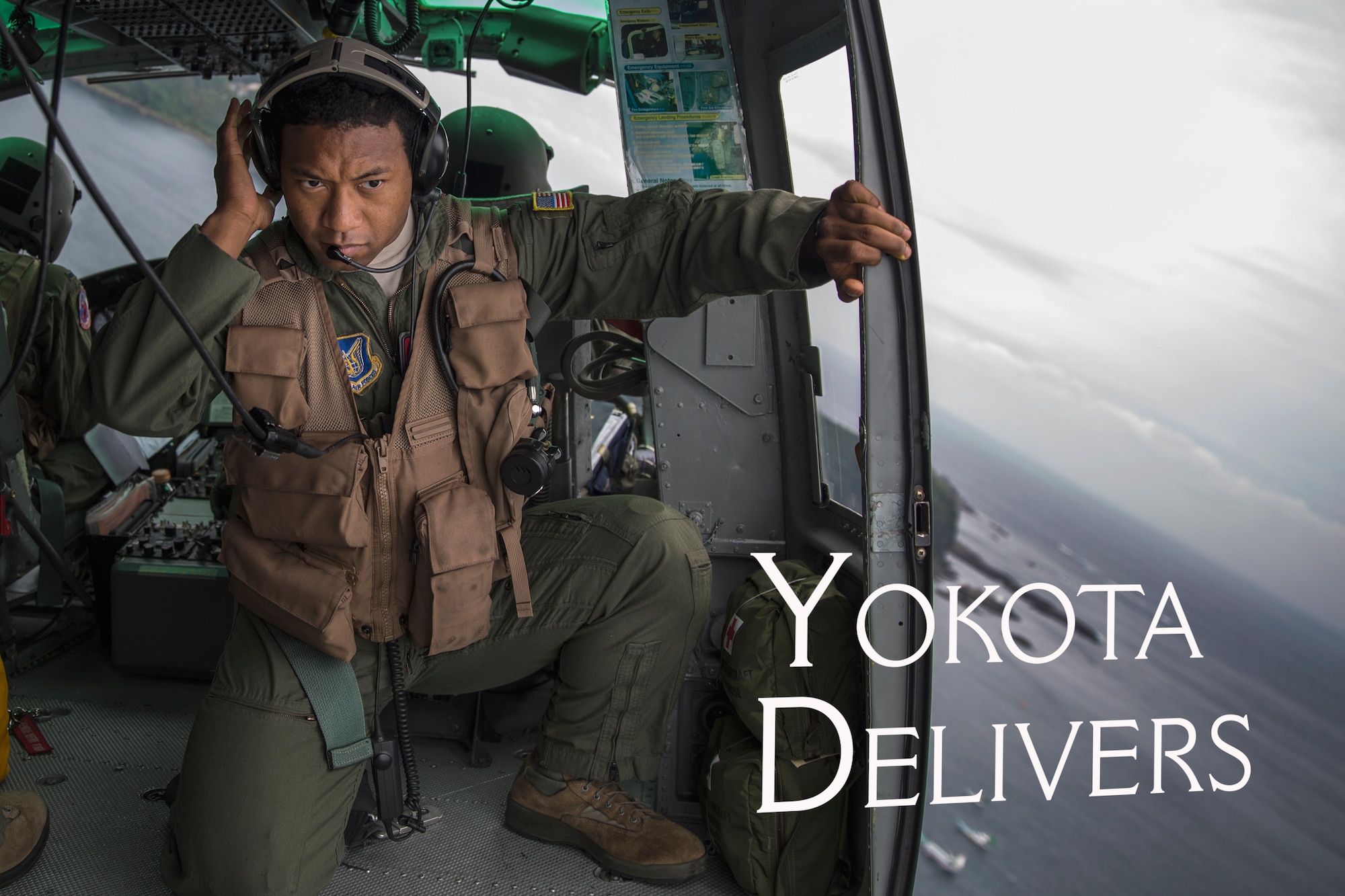 Maj. Zensaku Munn, 374th Operations Support Squadron air mobility liaison officer, listens to the radio over Shimoda bay, Shizuoka prefecture, Japan, Aug. 31, 2014, during the Shizuoka Comprehensive Disaster Drill. Munn relayed drop clearance to the inbound C-130 Hercules from a UH-1N Iroquois during the drill. (U.S. Air Force photo illustration by Osakabe Yasuo/Released)  