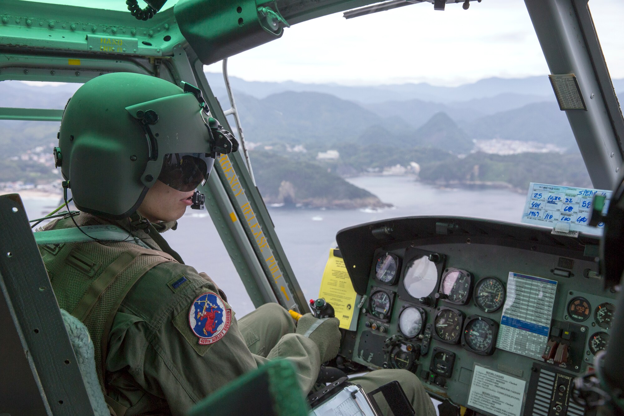 1st Lt. Daniel Trapani, 459th Airlift Squadron UH-1N pilot, flies over Sagami bay at Shizuoka prefecture, Japan, Aug. 31, 2014, during the Shizuoka Comprehensive Disaster Drill. UH-1N Iroquois crewmembers cleared a water Drop Zone for a C-130 Hercules airdrop. (U.S. Air Force photo by Osakabe Yasuo/Released)  