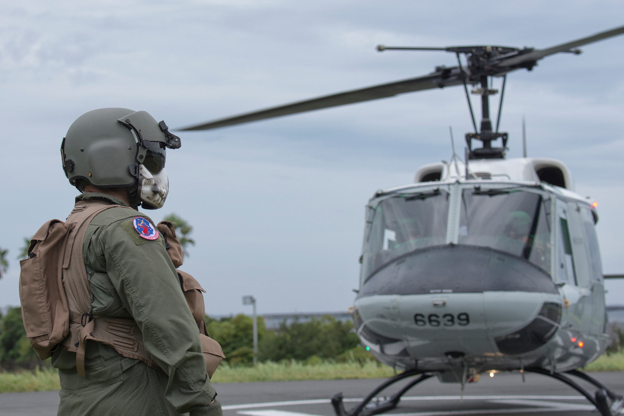 Staff Sgt. Christopher Rector, 459th Airlift Squadron flight engineer, performs an area clearance at Shimoda Helipad, Shizuoka prefecture, Japan, Aug. 31, 2014, during the Shizuoka Comprehensive Disaster Drill. UH-1N Iroquois crewmembers cleared a water Drop Zone for a C-130 Hercules airdrop. (U.S. Air Force photo by Osakabe Yasuo/Released)