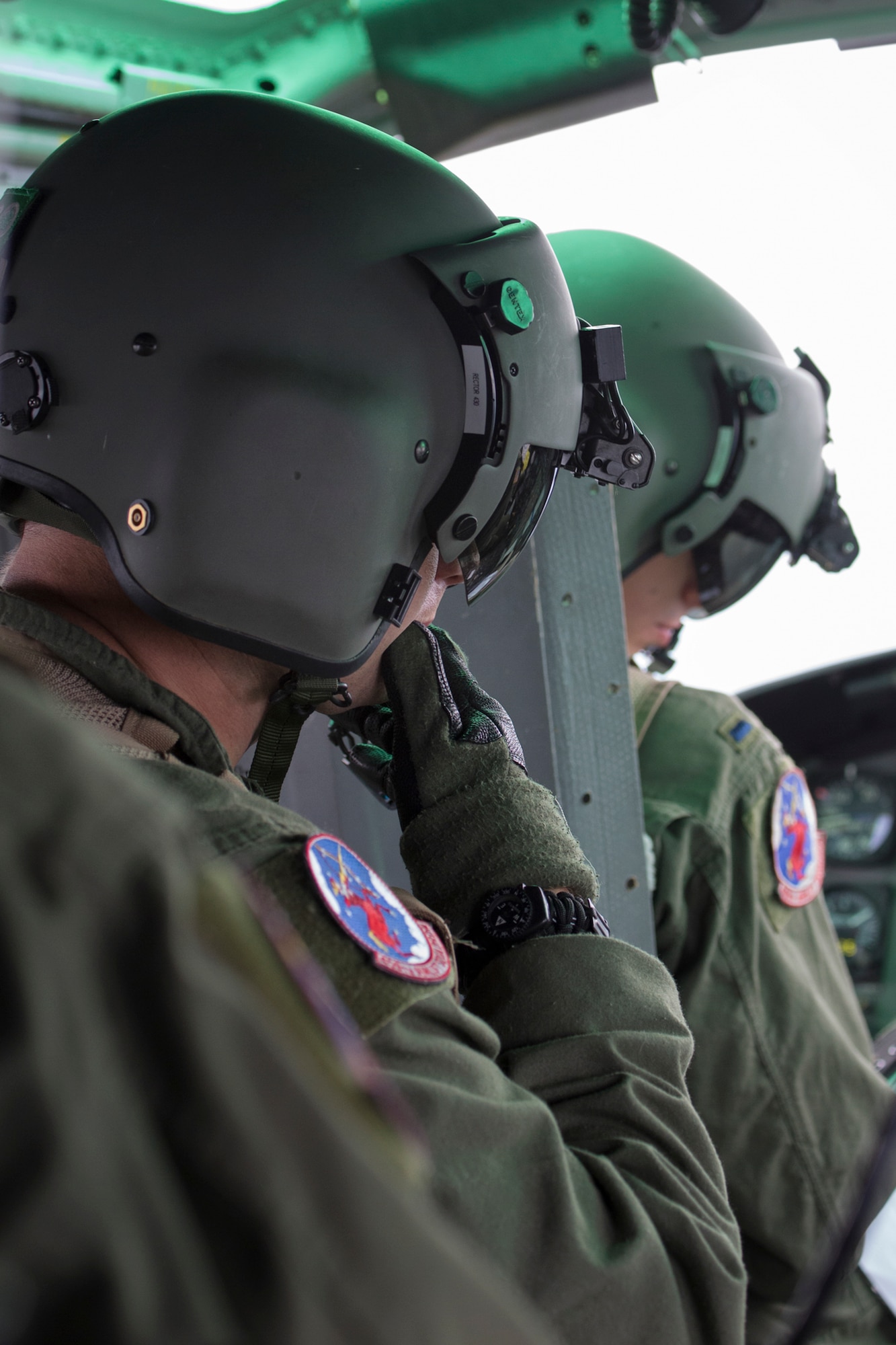 Left to right) Staff Sgt. Christopher Rector, 459th Airlift Squadron flight engineer, communicates with 1st Lt. Daniel Trapani, 459th pilot, during a flight over Shizuoka prefecture, Japan, Aug. 31, 2014. UH-1N Iroquois crewmembers participated in the Shizuoka Comprehensive Disaster Drill. (U.S. Air Force photo by Osakabe Yasuo/Released)