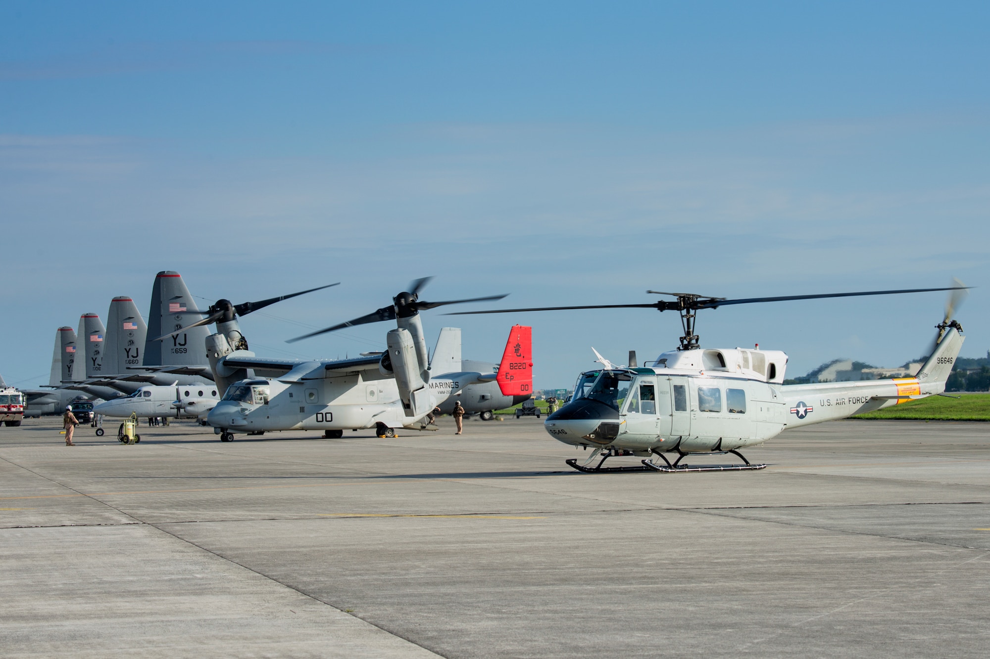 (Right to left) A UH-1N Iroquois from the 459th Airlift Squadron, a MV-22 Osprey from Marine Corps Air Station Futenma, a C-12 Huron from the 459th AS, and C-130 Hercules from the 36th Airlift Squadron are prepared for an exercise at Yokota Air Base, Japan, Aug. 31, 2014. (U.S. Air Force photo by Osakabe Yasuo/Released)