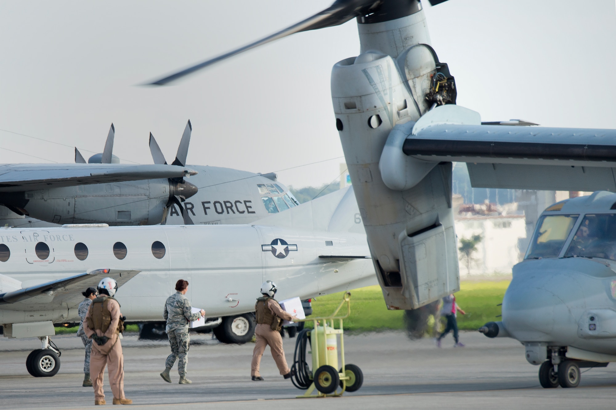 Airmen from the 374th Medical Group and Marines from Marine Corps Air Station Futenma load simulated relief supplies onto a MV-22 Osprey at Yokota Air Base, Japan, Aug. 31, 2014, during a joint humanitarian assistance and disaster relief exercise.  The Osprey displayed its range and speed by traveling round trip from Yokota to Oshima Island during the exercise. (U.S. Air Force photo by Osakabe Yasuo/Released)
