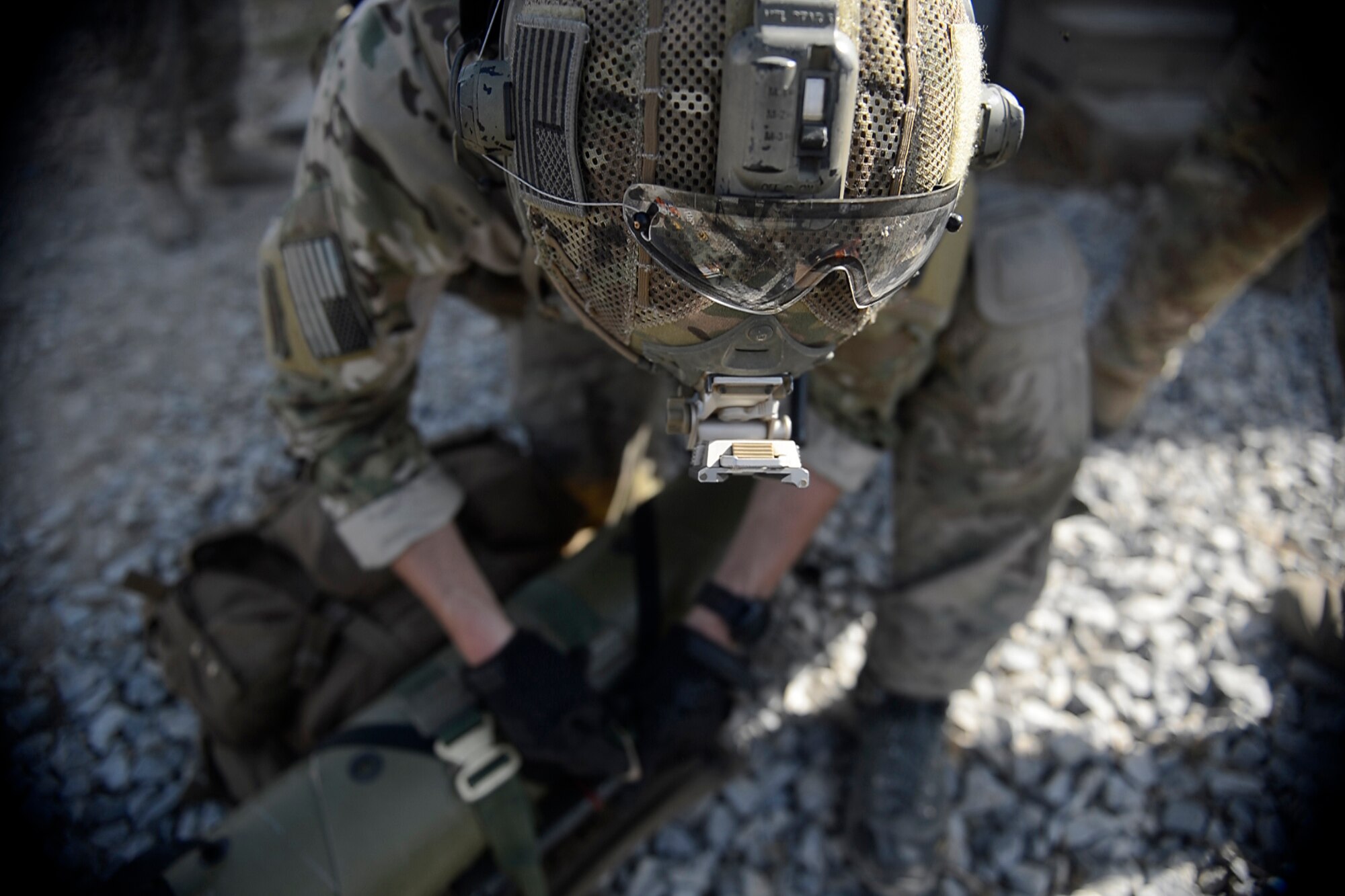 A U.S. Air Force Airman from the 83rd Expeditionary Rescue Squadron packs his gear during a mission rehearsal at Bagram Airfield, Afghanistan Aug. 26, 2014. During the rehearsal, they breached and cleared a building to rescue a simulated casualty. (U.S. Air Force photo by Staff Sgt. Evelyn Chavez/Released)