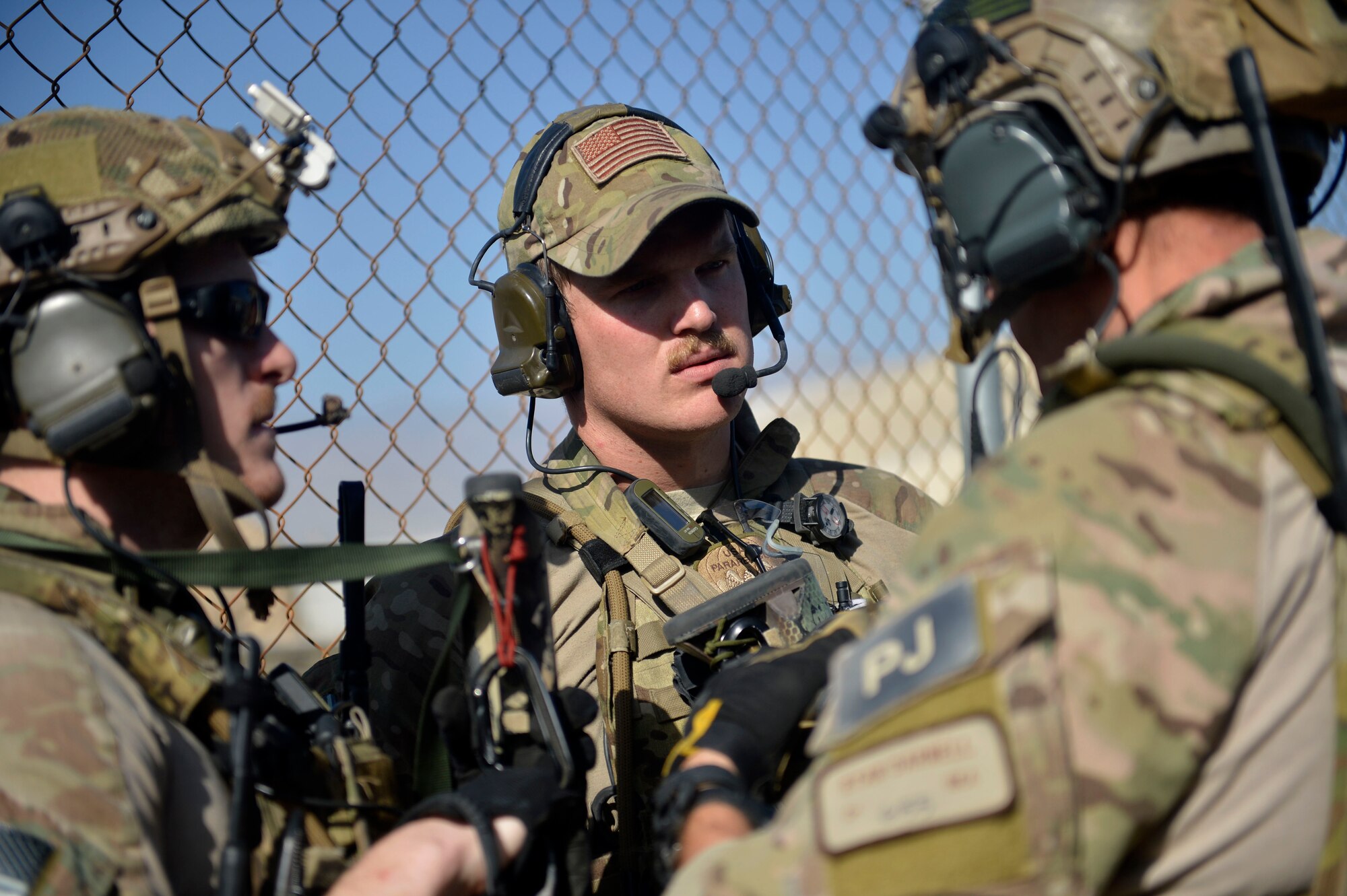 U.S. Air Force Senior Airman Jake Racicot 83rd Expeditionary Rescue Squadron pararescue team member, speaks to his team before a mission rehearsal at Bagram Airfield, Afghanistan Aug. 26, 2014.  The unit honed their skills during a mission rehearsal by practicing breaching, clearing, rescuing a simulated casualty, and eggressing. Racicot is deployed from Davis-Monthan Air Force Base, Ariz. and a native of Reno, Nev. (U.S. Air Force photo by Staff Sgt. Evelyn Chavez/Released)
