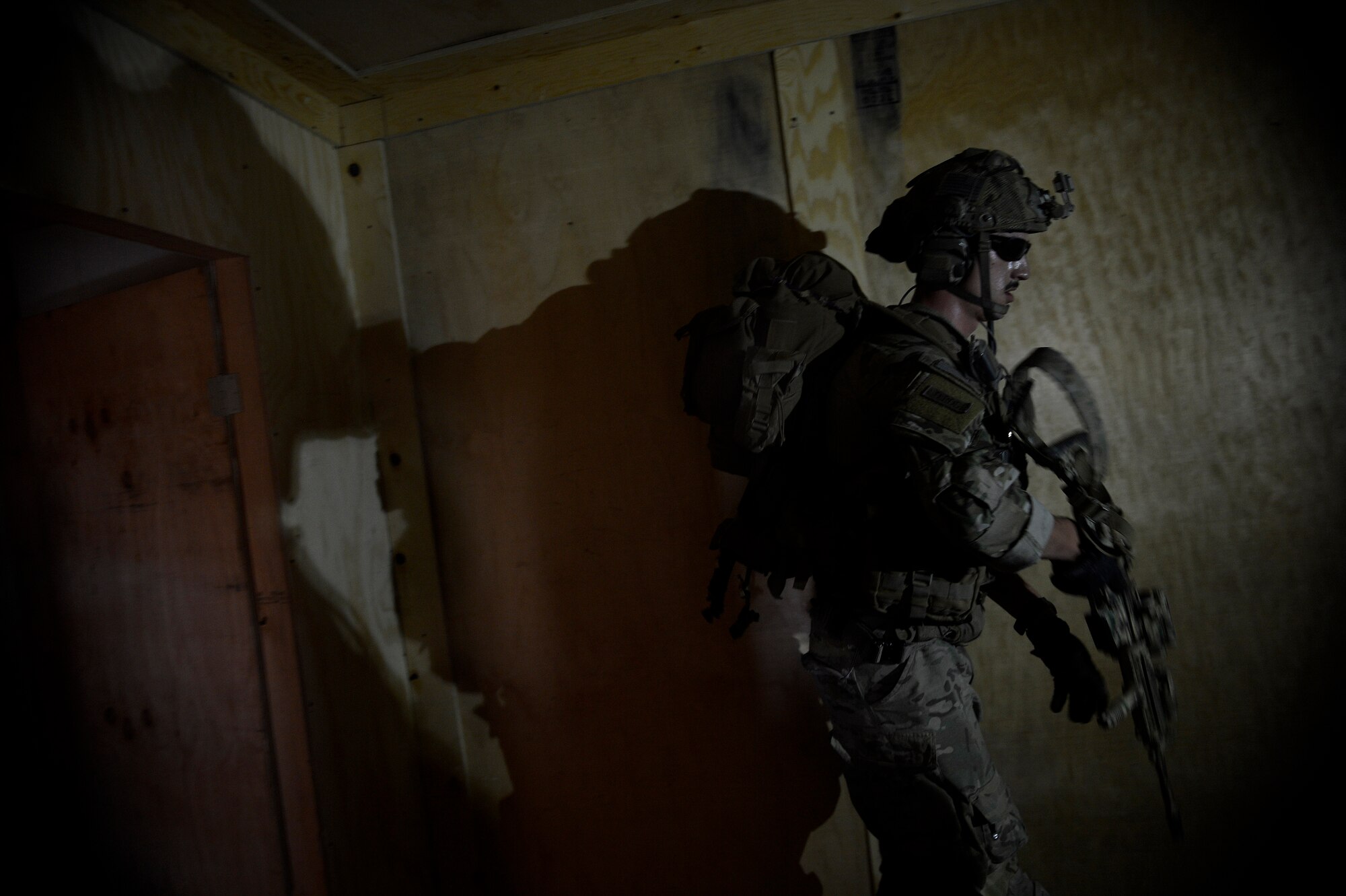 U.S. Air Force Senior Airman Thomas Schalin, 83rd Expeditionary Rescue Squadron pararescueman, clears a building during a mission rehearsal at Bagram Airfield, Afghanistan Aug. 26, 2014.  The unit honed their skills during a mission rehearsal by practicing breaching, clearing, rescuing a simulated casualty and egressing. Schalin is deployed from Davis-Monthan Air Force Base, Ariz. and a native of Great Falls, Mont. (U.S. Air Force photo by Staff Sgt. Evelyn Chavez/Released)