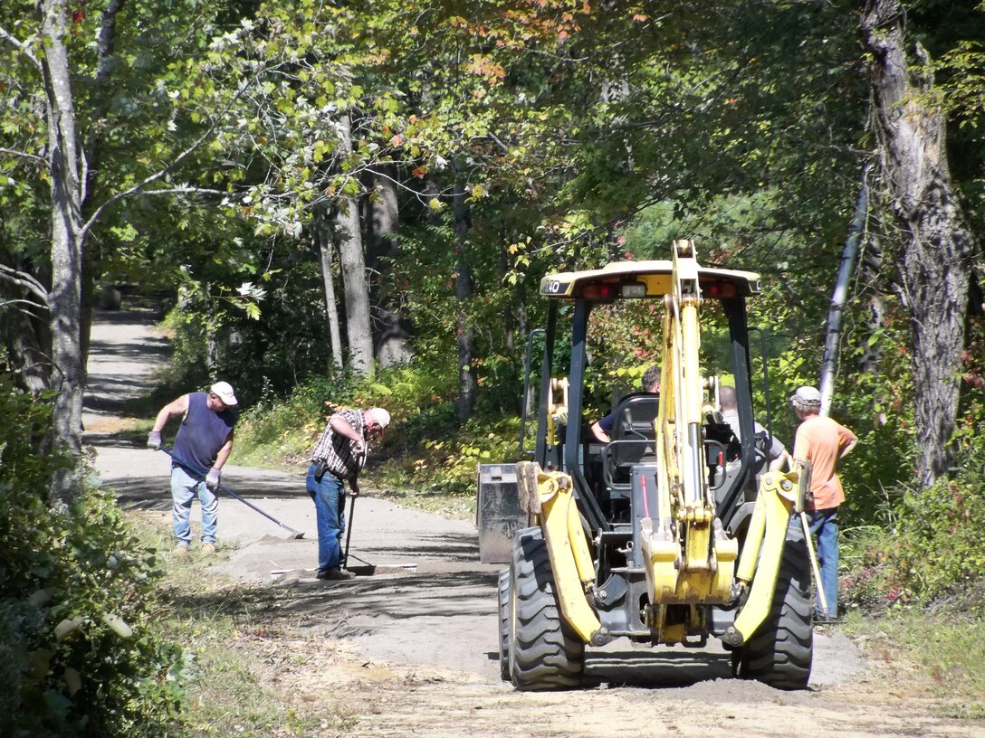 Volunteers spreading and leveling a new fine gravel surface on a section of  Lake Siog Trail at East Brimfield Lake, Brimfield, Mass., for National Trail Day, June 7, 2014.