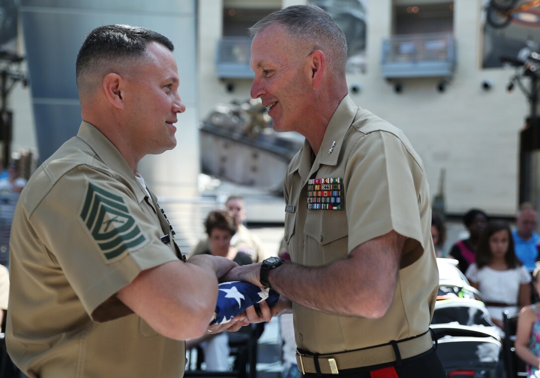 Quantico, VA. - Major General Mark A. Brilakis, commanding general, Marine
Corps Recruiting Command, presents Master Sgt. Eric M. Hickman, career
retention specialist, with an American flag during Hickman's
retirement ceremony at the National Museum of the Marine Corps, Aug. 29.
After more than 22 years of honorable and faithful service in the Marine
Corps, Hickman is just one of the many outstanding American citizens the
Corps will return back into the community.

