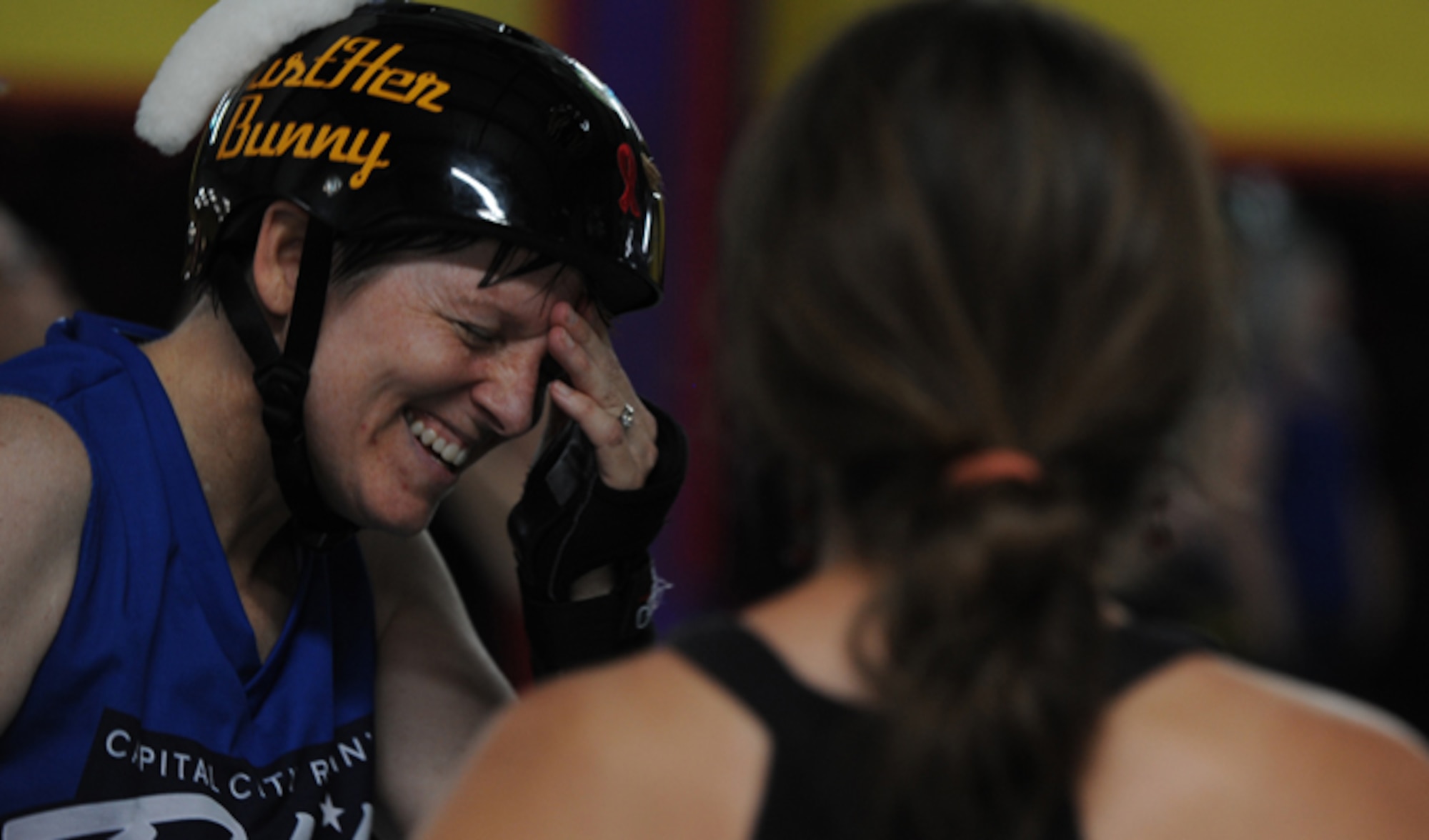 Lt. Col. Melanie Friedman meets with her friends after the Capitol City Rollin’ Rebels and Mobile Derby Darlins’ roller derby bout Aug.9, 2014, in Montgomery, Ala. Friedman’s friends and family often attend bouts to watch the Rebels play and support Friedman, the Curtis E. Lemay Center for Doctrine Development and Education deputy director of intelligence. (U.S. Air Force photo/Staff Sgt. Natasha Stannard)