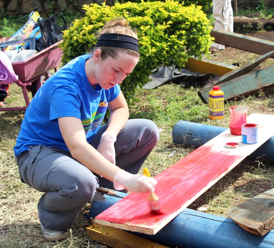Brianne Poole, 17-year-old daughter of engineer Brian Poole, U.S. Army Corps of Engineers Sacramento District, adds some color to a construction project during an August mission trip to Tanzania, Africa, in August 2014. Brianne hopes to follow in her dad’s footsteps and recently began college studies to become an engineer.