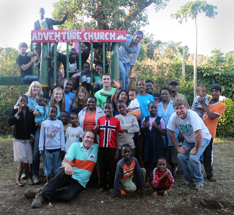 Children of Samaritan Village and their new friends from Yuba City, California, pose for one final shot after construction of new playground equipment at the orphanage near Arusha, Tanzania. The Yuba City team spent two weeks in Tanzania in August 2014, improving orphanage facilities and meeting the kids.