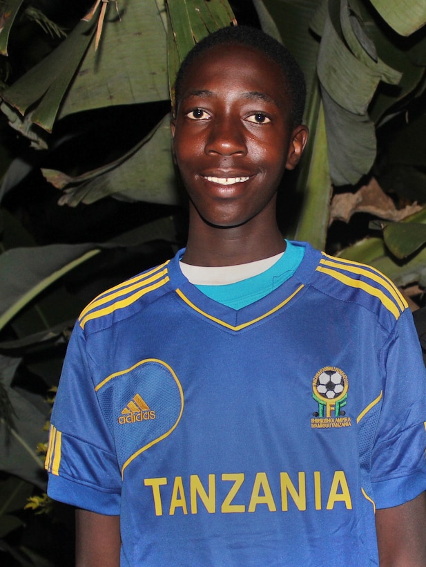 Moses, 14, proudly wears a new soccer jersey given to him by one of the Yuba City, California, volunteers who visited in August 2014 the Tanzanian orphanage where Moses has grown up.