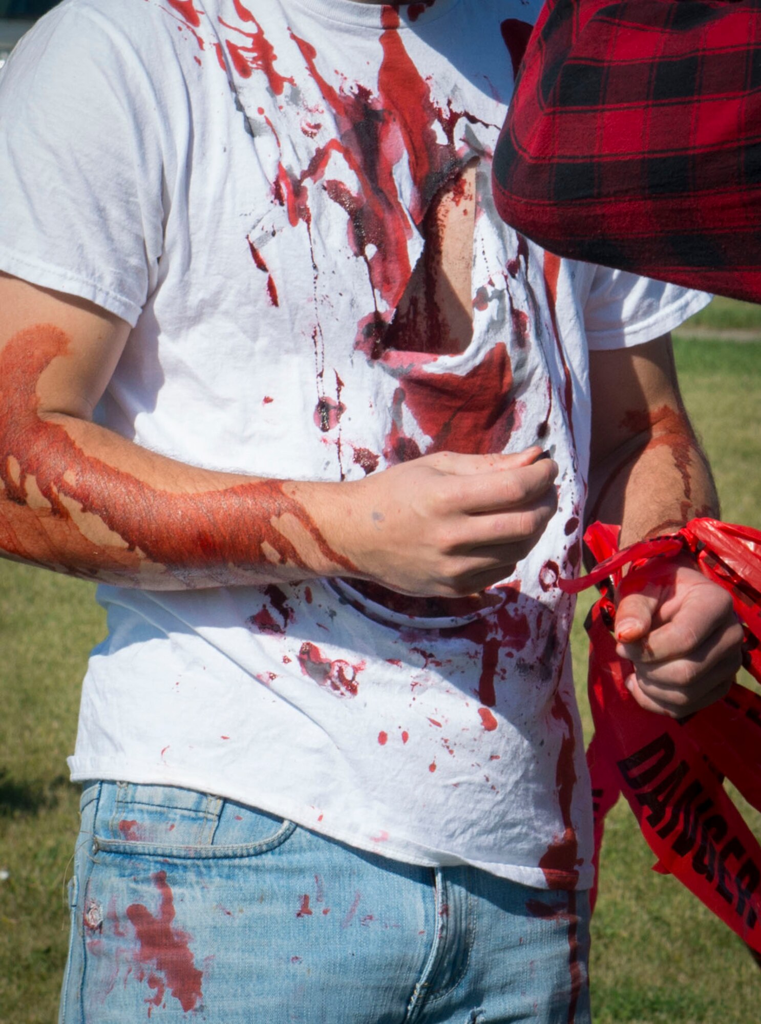 A zombie attaches captured flags around his wrist at Minot Air Force Base, N.D., Aug. 30, 2014. As runners dashed across the field, zombies chased them and attempted to snatch their remaining flags. (U.S. Air Force photo/Airman 1st Class Sahara L. Fales)