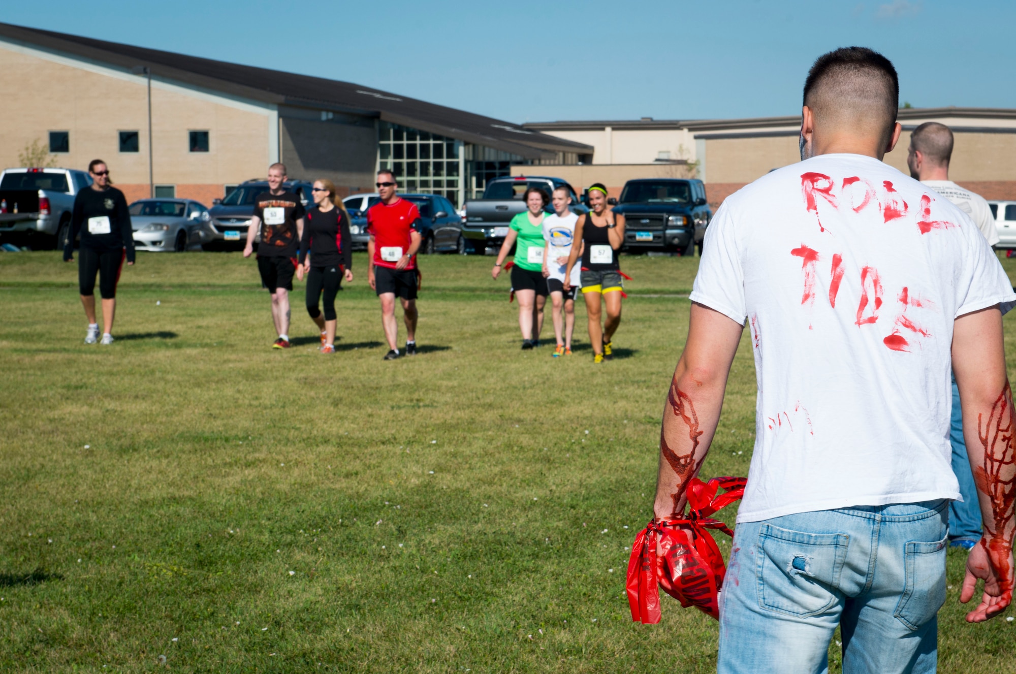 Zombies wait for runners participating in the Apocalypse Runs North 5K to arrive on the soccer field at Minot Air Force Base, N.D., Aug. 30, 2014. The runners’ goal was to make it across the field without having their flag captured by a zombie. (U.S. Air Force photo/Airman 1st Class Sahara L. Fales)