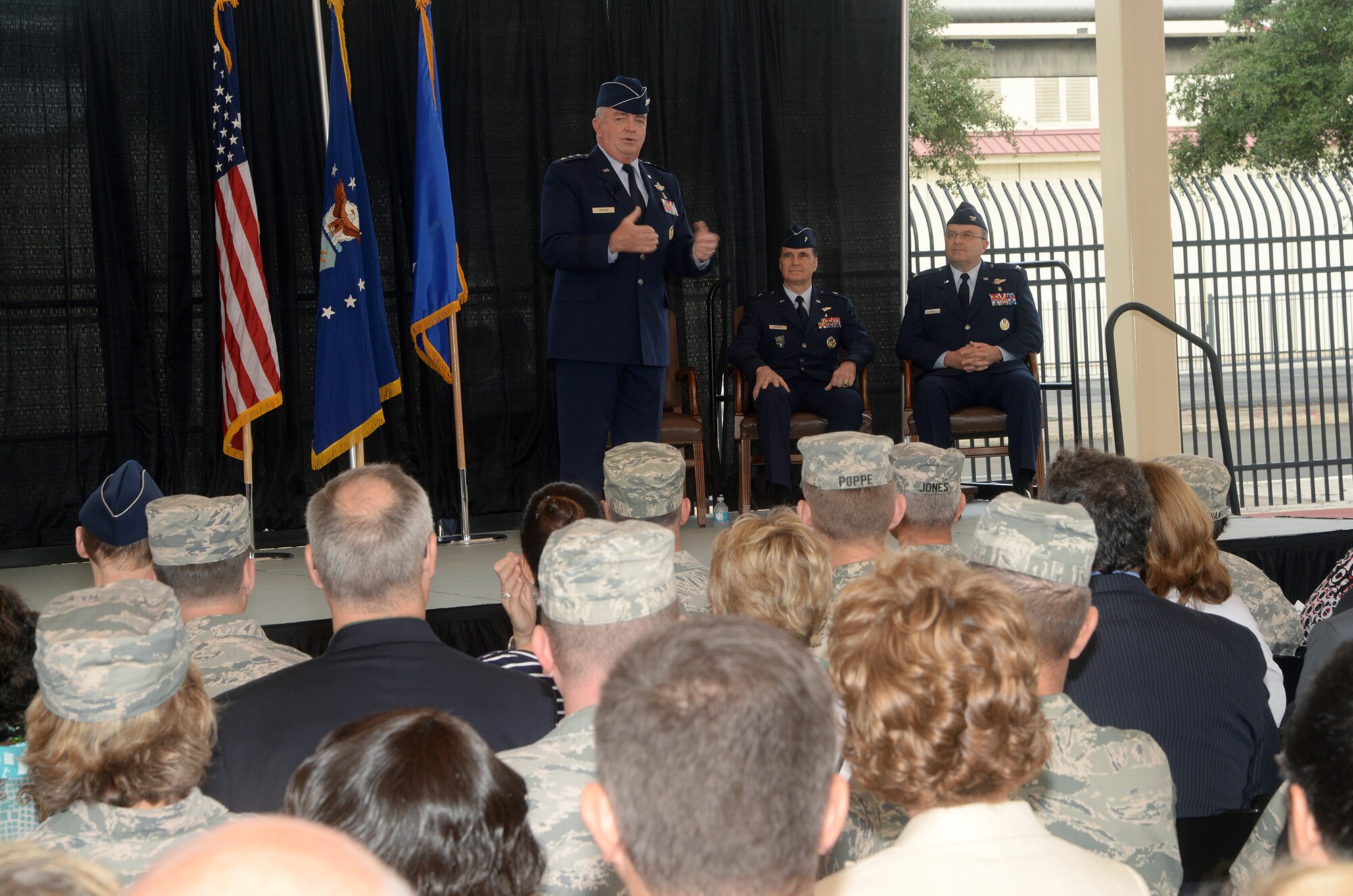 Lt. Gen. Thomas W. Travis, Surgeon General of the Air Force, addresses attendees at the Air Force Medical Operations Agency change of command ceremony as Brig. Gen. Sean L. Murphy, outgoing AFMOA commander, and Col. Lee A. Payne, incoming AFMOA commander, look on at Joint Base San Antonio-Lackland Kelly Field Annex Aug. 29, 2014. AFMOA oversees the execution of the Air Force Surgeon General policies supporting Air Force expeditionary capabilities, healthcare operations and national security strategy. Col. Payne will be responsible for leading consultative support of over 43,000 personnel, 75 Medical Treatment Facilities with a $6.1 billion budget. (U.S. Air Force Photo by Johnny Saldivar)