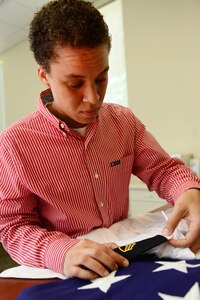 Amber Hendricks, Army Support Activity mortuary affairs coordinator, ensures a rank is properly placed on a uniform shirt at Fort Eustis, Va., Aug. 26, 2014. Hendricks’ duties include making sure the uniform of a deceased U.S. Army Soldier is in proper order and making arrangements for the Service member’s family to attend the funeral. (U.S. Air Force photo by Airman 1st Class Kimberly Nagle/Released)   

