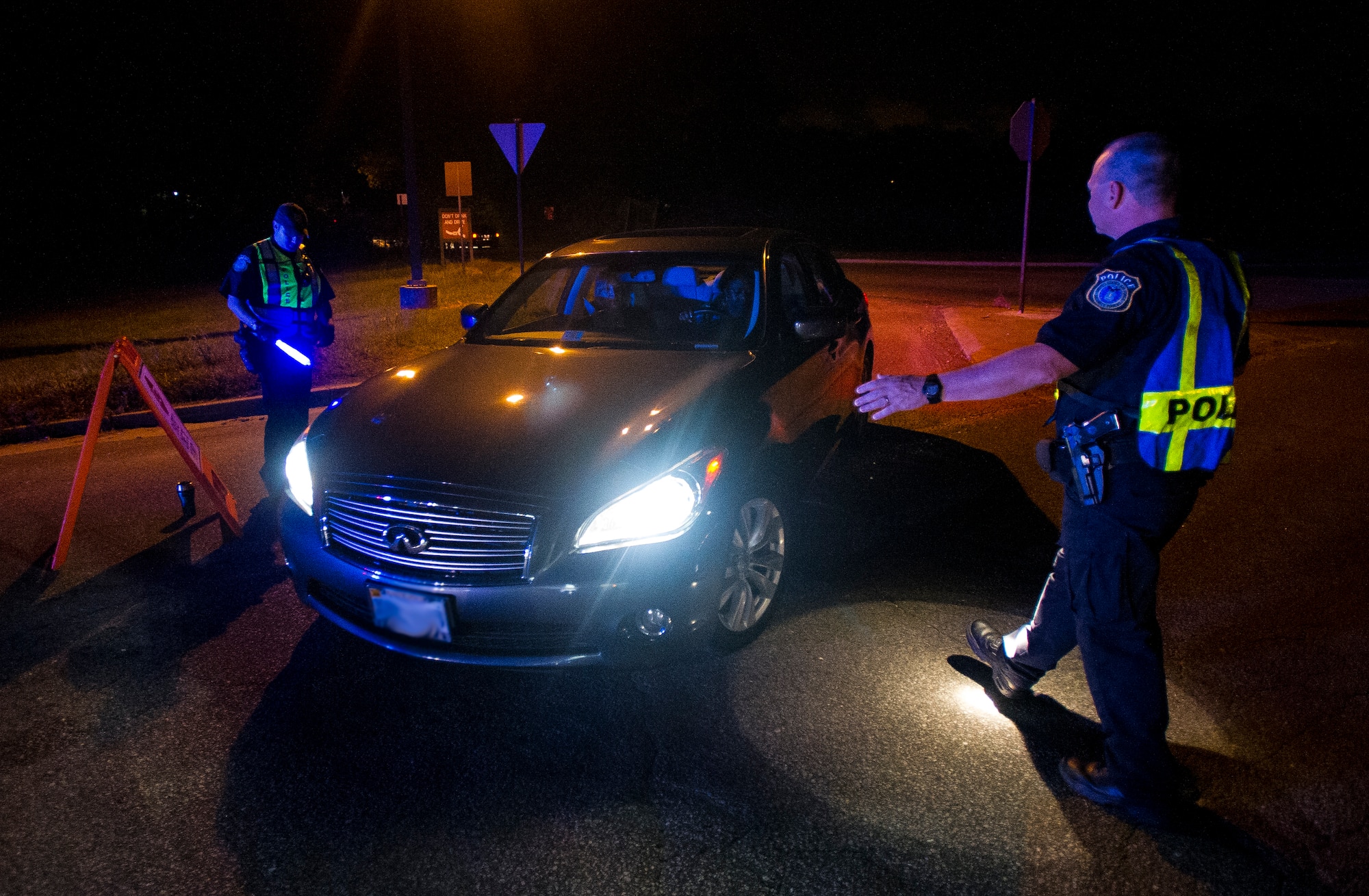 Robert Clark, 628th Security Forces Squadron patrolman, stops a car as it pulls up to a DUI checkpoint, Aug. 29, 2014, in North Charleston. The checkpoint was held as a joint effort between 628th Security Forces Squadron patrolmen and local sheriffs and police officers.  (U.S. Air Force photo/Staff Sgt. William O'Brien)