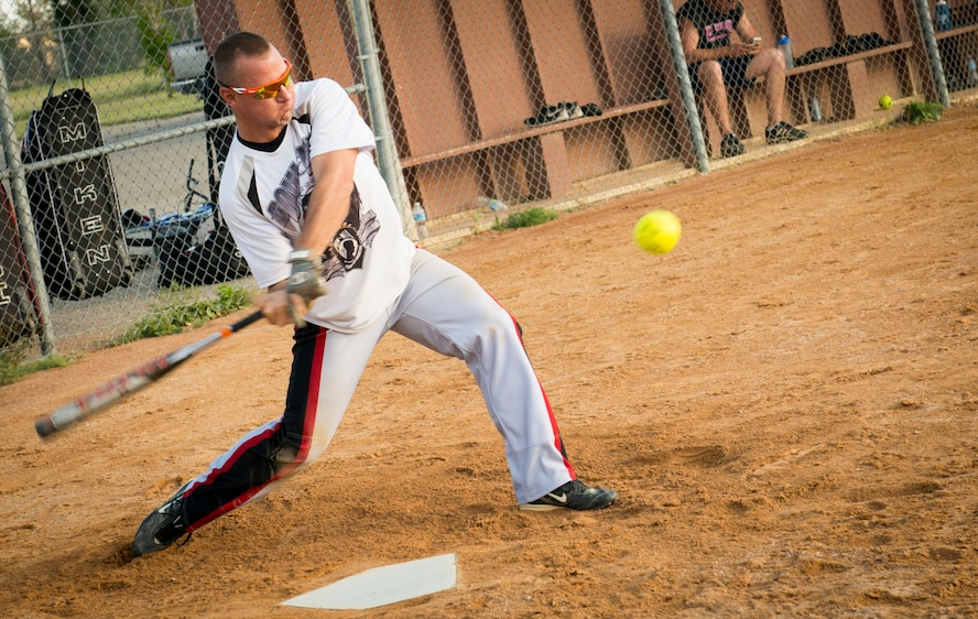 Jonathan Mabie, 5th Logistics Readiness Squadron team member, prepares to hit a ball at Minot Air Force Base, N.D., Aug. 26, 2014. Airmen from the 5 LRS competed against the 705th Munitions Squadron during the intramural softball championship. (U.S. Air Force photo/Airman 1st Class Sahara L. Fales)