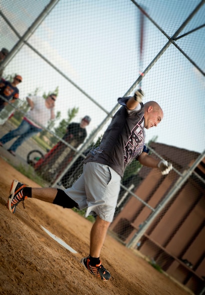 Louis Kane, 705th Munitions Squadron softball team member, hits a softball at Minot Air Force Base, N.D., Aug. 26, 2014. Airmen from the 705th Munitions Squadron competed against a group of Airmen from the 5th Logistics Readiness Squadron in the intramural softball championship game. (U.S. Air Force photo/Airman 1st Class Sahara L. Fales)