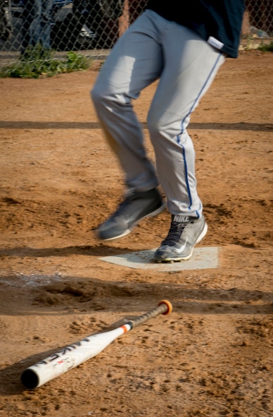 A player crosses home plate at Minot Air Force Base, N.D., Aug. 26, 2014. Airmen from the 705th Munitions Squadron competed against a group of Airmen from the 5th Logistics Readiness Squadron in the intramural softball championship game. (U.S. Air Force photo/Airman 1st Class Sahara L. Fales)