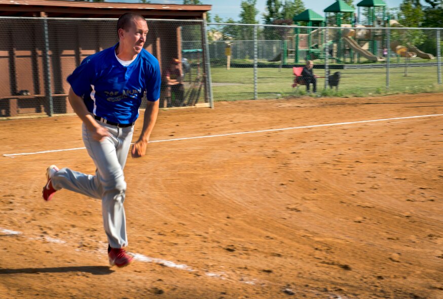 Michael Phillips, captain of the 705th Munitions Squadron softball team, runs to first base at Minot Air Force Base, N.D., Aug. 26, 2014. The game ended with a final score of 9-5, a win by the 705 MUNS. (U.S. Air Force photo/Airman 1st Class Sahara L. Fales))