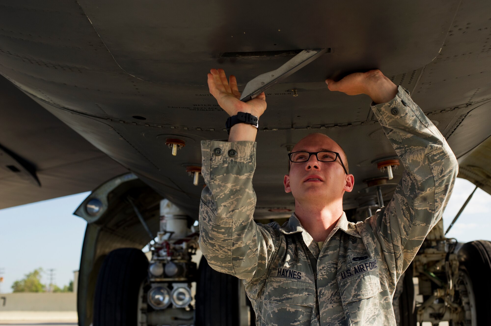 Senior Airman Quentin Haynes, 5th Aircraft Maintenance Squadron crew chief, inspects the hatch door of a B-52H Stratofortress during a preflight inspection on Minot Air Force Base, N.D., Aug. 28, 2014. Haynes is part of the crew chief team that will represent Minot AFB in the Global Strike Challenge. The team will be evaluated on how they perform their pre-flight inspections and knowledge of their job. (U.S. Air Force photo/Senior Airman Brittany Y. Bateman) 