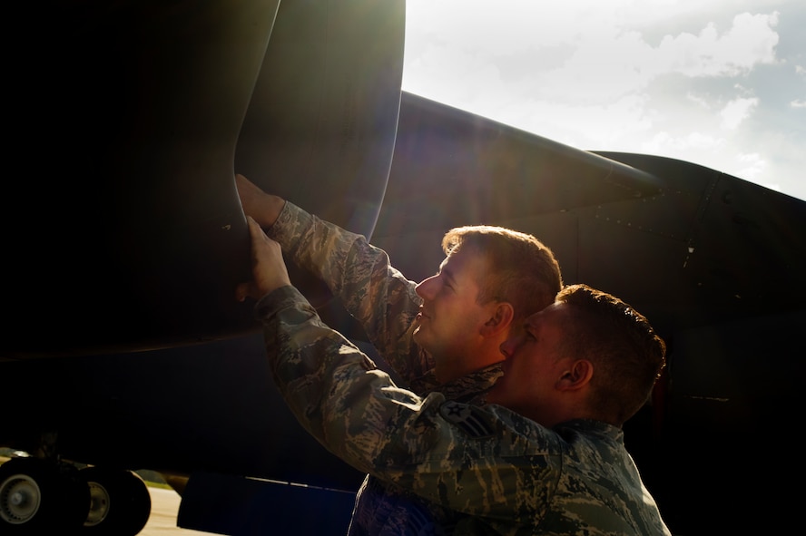 Staff Sgt. Brett Jordan and Senior Airman Kevin Carmel, 5th Aircraft Maintenance Squadron crew chiefs, inspect the engine of a B-52H Stratofortress during a pre-flight inspection on Minot Air Force Base, N.D., Aug. 28, 2014. Jordan and Carmel are part of the crew chief team that will represent Minot AFB in the Global Strike Challenge. (U.S. Air Force photo/Senior Airman Brittany Y. Bateman) 