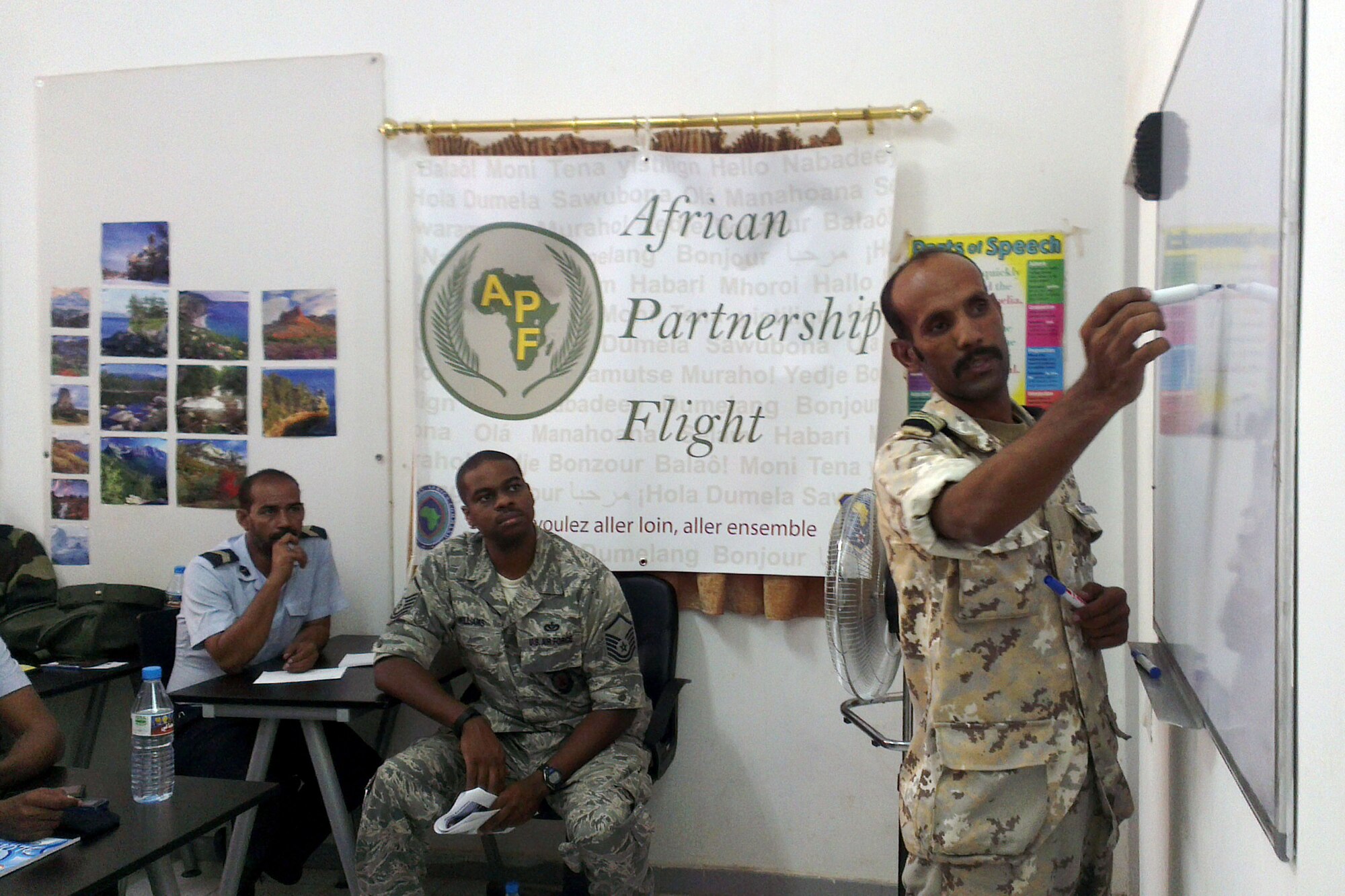 Mauritanian air force Sgt. Chief Bouha Khayri, airplane mechanic, discusses with the African Partnership Flight Mauritania ground safety students and U.S. Air Force Master Sgt. Jerome Williams, ground safety instructor from the 818th Mobility Support Advisory Squadron, Joint Base McGuire-Dix-Lakehurst, N.J., a Bird/wildlife Aircraft Strike Hazard scenario that is relevant to the Mauritanian air force and the base he is assigned to during the APF ground safety class at Atar Airbase, Atar, Mauritania, Sept. 2, 2014. APF Mauritania offers students from six participating African countries lessons on ground and flight safety, Intelligence Surveillance and Reconnaissance, and air command operations. (U.S. Air Force photo/Master Sgt. Brian Boisvert/Released) 