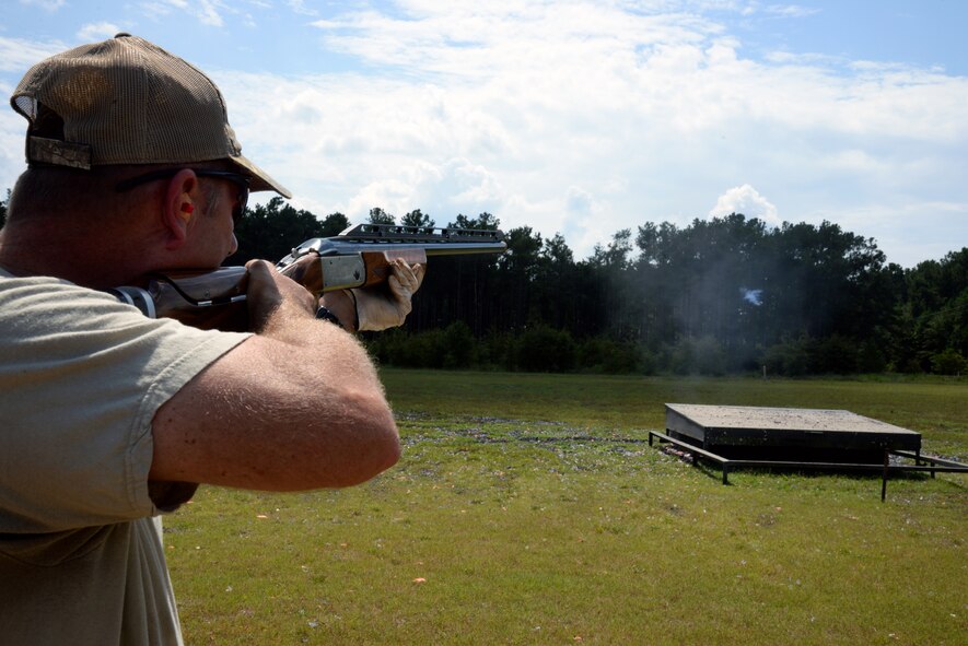 U.S. Army Col. Michael Cook, U.S. Army Central training and operations deputy, fires his shotgun and watches as his target shatters after making contact with it during a trap shooting at the 20th Force Support Squadron trap and skeet range at Shaw Air Force Base, S.C., Sept. 2, 2014. Cook has been shooting at Shaw since he arrived in March and appreciates the camaraderie that shooting at the skeet range brings. (U.S. Air Force photo by Airman 1st Class Jonathan Bass/Released)