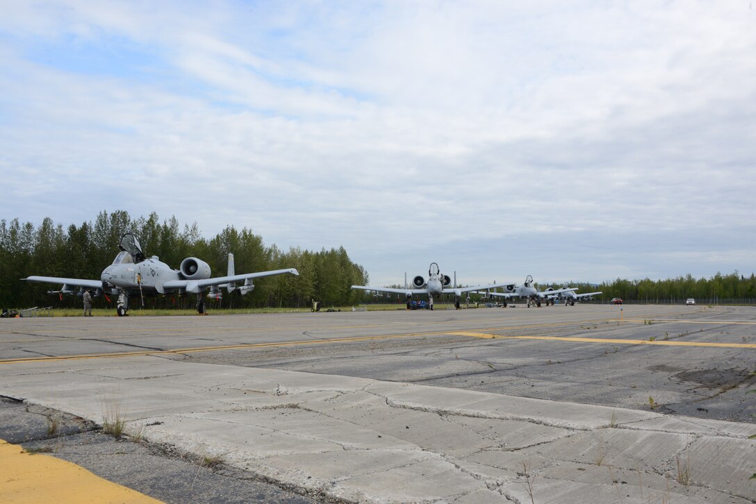 After the pre-flight inspection process is completed at Exercise Red Flag 14-3, Eielson Air Force Base, Ak., 4 A-10C Thunderbolt II aircraft from Warfield Air National Guard Base, Baltimore, Md. are ready for taxiing and take-off. Exercise Red Flag – Alaska is a 10 day exercise that is a series of Pacific Air Forces commander-directed field training exercises for U.S. forces, provides joint offensive counter-air, interdiction, close air support, and large force employment training in a simulated combat environment. (Air National Guard photo by Tech. Sgt. Christopher Schepers/RELEASED)