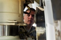Senior Airman Kevin Carmel, 5th Aircraft Maintenance Squadron crew chief, performs a pre-flight inspection on a B-52H Stratofortress on Minot Air Force Base, N.D., Aug. 28, 2014. Carmel is part of the crew chief team that will represent Minot AFB in the Global Strike Challenge. The team will be evaluated on how they perform their pre-flight inspections and knowledge of their job. (U.S. Air Force photo/Senior Airman Brittany Y. Bateman) 