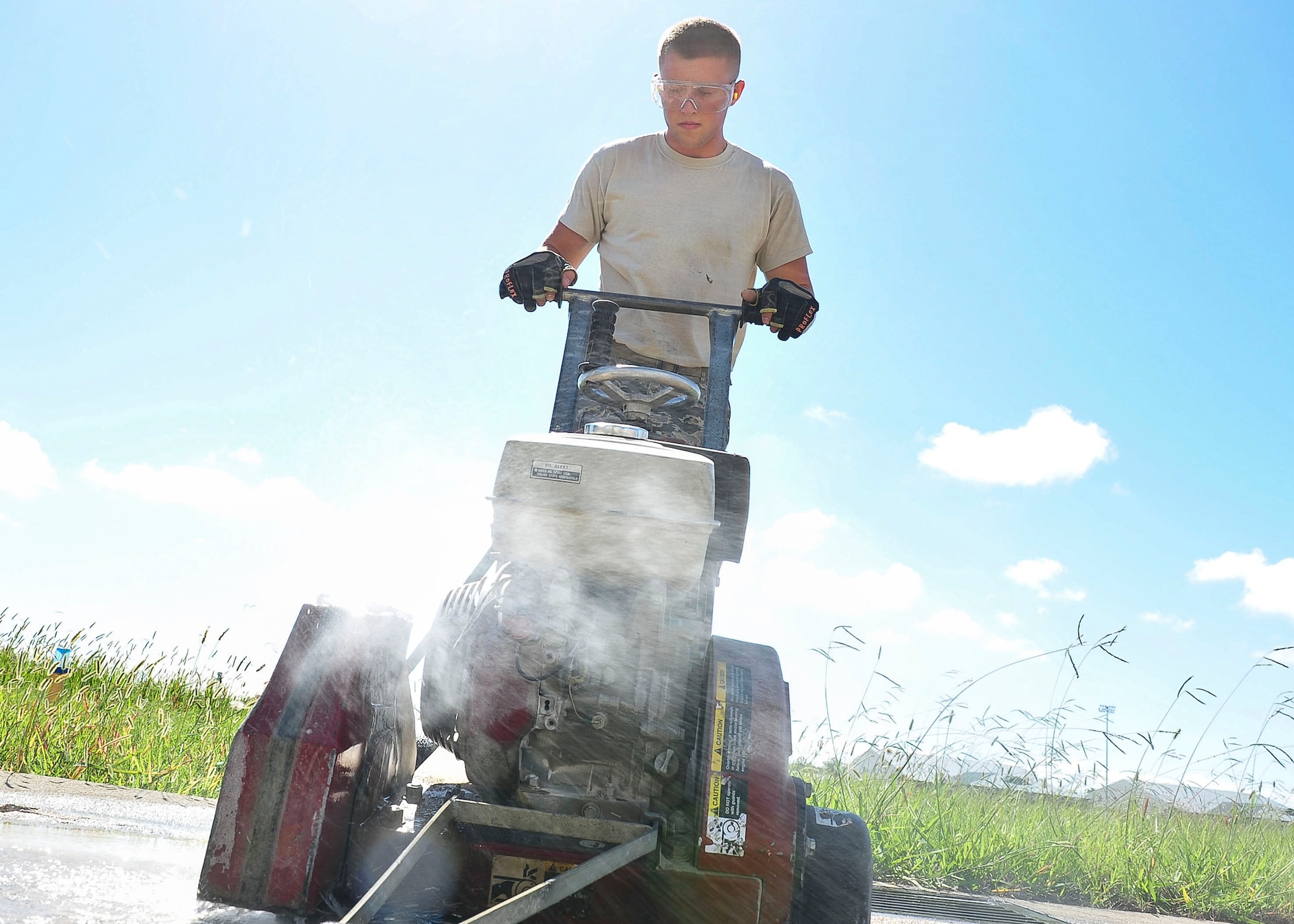 U.S. Air Force Senior Airman Christopher Krahn, 633rd Civil Engineer Squadron pavements and equipment craftsmen, cuts a section of the runway at Langley Air Force Base, Va., Aug. 27, 2014.  Civil Engineer pavements and equipment Airmen, commonly known as the Dirt Boyz,  job functions include patch work on roads, parking lots and runways. (U.S. Air Force photo by Senior Airman Connor Estes/Released)