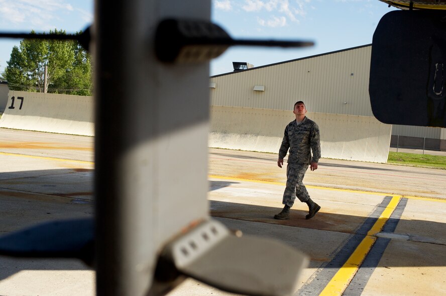 Senior Airman Kevin Carmel, 5th Aircraft Maintenance Squadron crew chief, performs a pre-flight inspection on a B-52H Stratofortress on Minot Air Force Base, N.D., Aug. 28, 2014. Carmel is part of the crew chief team that will represent Minot AFB in the Global Strike Challenge. The team will be evaluated on how they perform their pre-flight inspections and knowledge of their job. (U.S. Air Force photo/Senior Airman Brittany Y. Bateman) 