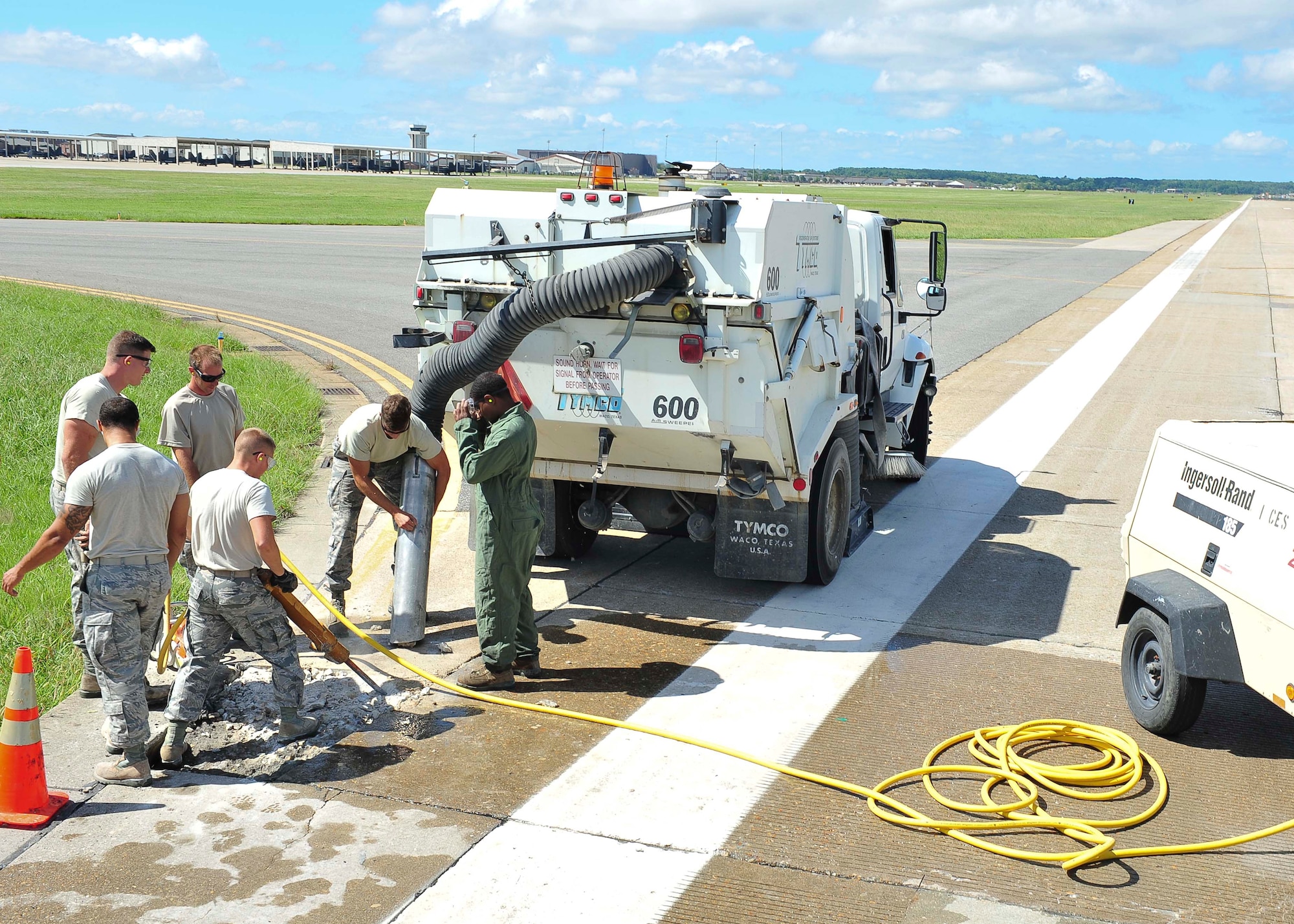 U.S. Air Force 633rd Civil Engineer Squadron pavements and equipment Airmen, nicknamed the Dirt Boyz, repair sections of the runway at Langley Air Force Base, Va., Aug. 27, 2014.  According to 633rd CES leadership the improvements will provide a safe environment to sustain current flying operations, and secure future mission capability.  (U.S. Air Force photo by Senior Airman Connor Estes/Released)