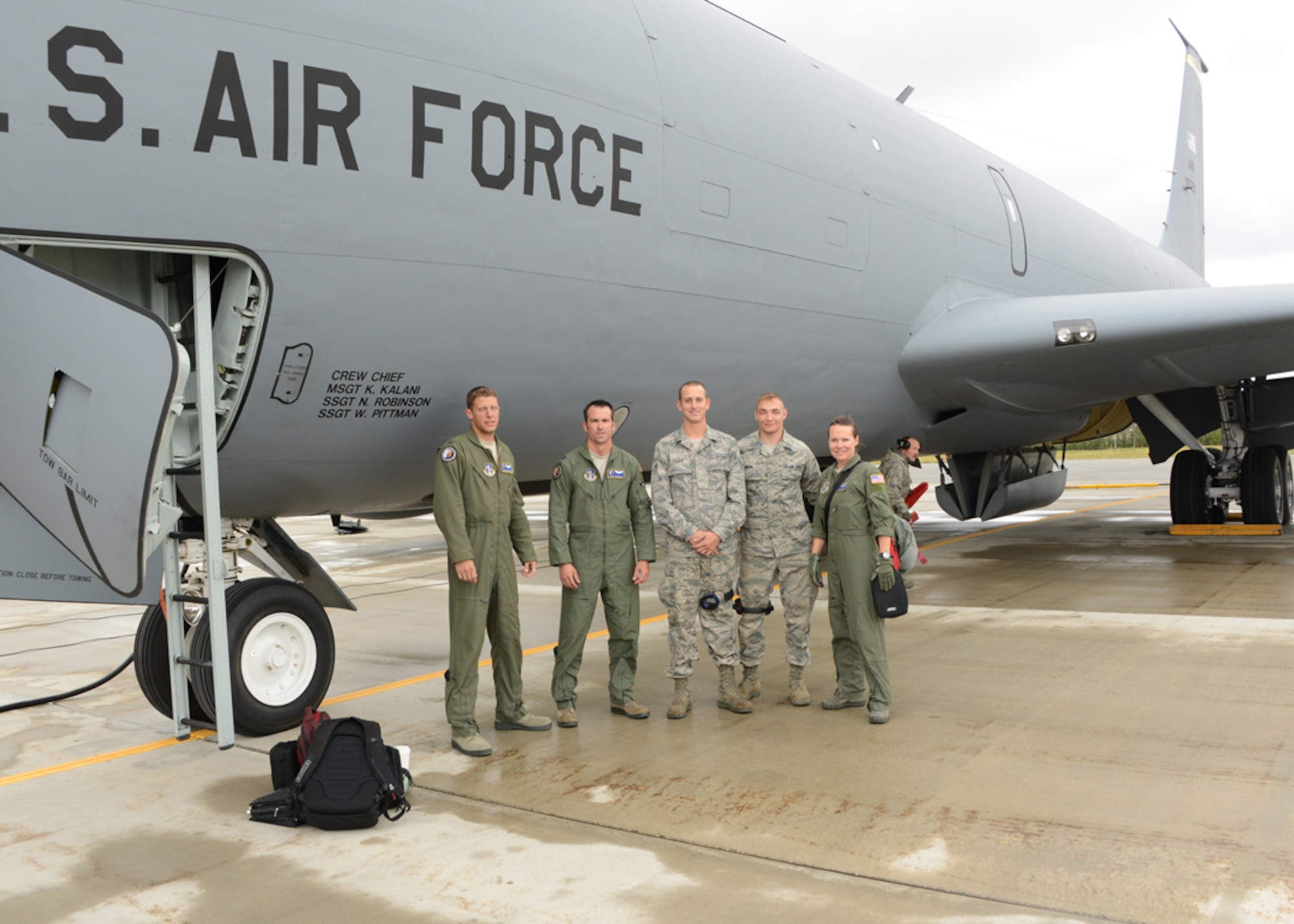 Airman 1st Class Joseph Fisher and Senior Airman Jesse Swain pose with the crew of a KC-135 Stratotanker after their incentive flight for outstanding work performed during Exercise Red Flag 14-3 with the 175th Maintenance Group, Maryland Air National Guard, Baltimore, Md., August 19, 2014. Exercise Red Flag is a 10 day exercise that is a series of Pacific Air Forces commander-directed field training exercises for U.S. forces, provides joint offensive counter-air, interdiction, close air support, and large force employment training in a simulated combat environment. (Air National Guard photo by Tech. Sgt. Christopher Schepers/RELEASED)