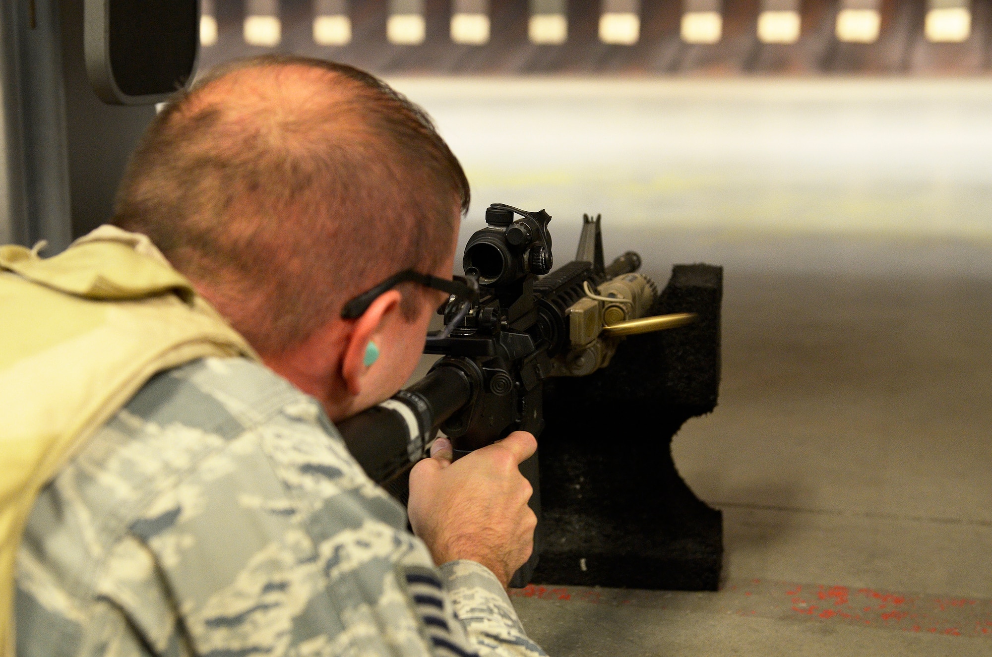 WRIGHT-PATTERSON AIR FORCE BASE, Ohio – Tech. Sgt. Ryan LaMarr, 445th Security Forces Squadron squad leader, fires an M4 assault rifle at a target while participating in the M4 Air Force Qualification Course at the Wright-Patt Combat Arms Training and Maintenance firing range here Aug. 2, 2014. Members of the 445 SFS retake the course every six months in order to stay qualified with the M9. (U.S. Air Force photo/Senior Airman Devin Long)