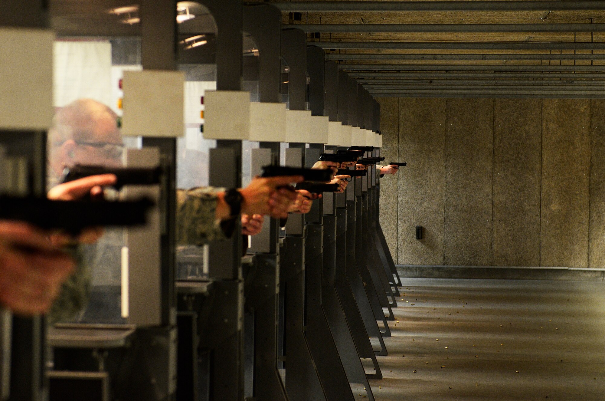 WRIGHT-PATTERSON AIR FORCE BASE, Ohio – 445th Security Forces Squadron Airmen fire M9 handguns at targets while participating in the M9 Air Force Qualification Course at the Wright-Patt Combat Arms Training and Maintenance firing range here Aug. 2, 2014. The course requires shooters to fire 45 rounds from different firing positions and distances. (U.S. Air Force photo/Senior Airman Devin Long)