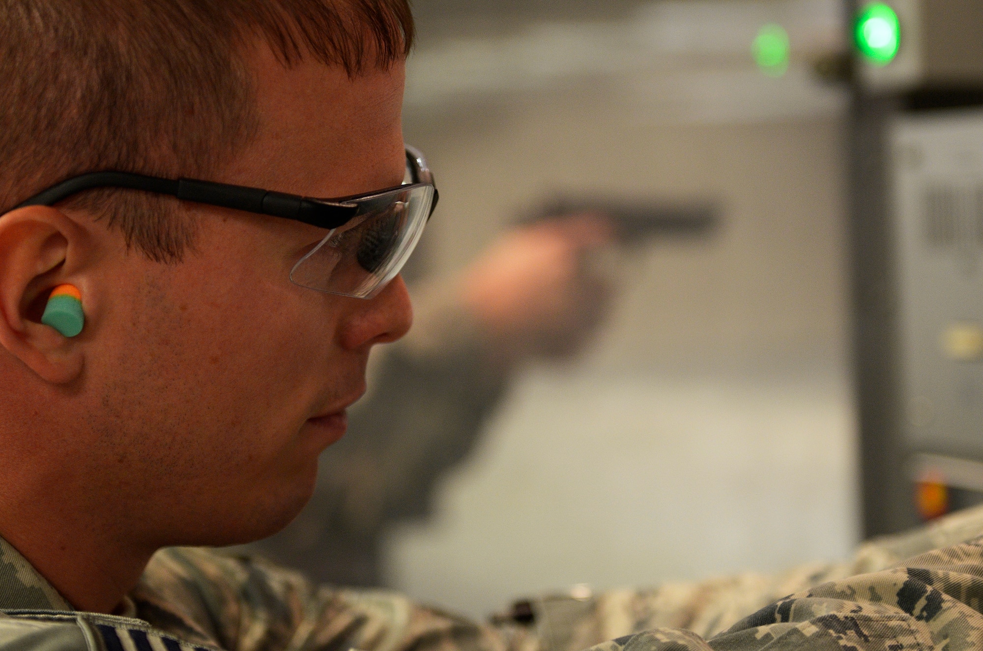 WRIGHT-PATTERSON AIR FORCE BASE, Ohio – Tech. Sgt. Ryan LaMarr, 445th Security Forces Squadron squad leader, fires an M9 handgun at a target while participating in the M9 Air Force Qualification Course at the Wright-Patt Combat Arms Training and Maintenance firing range here Aug. 2, 2014. Members of the 445 SFS retake the course every six months in order to stay qualified with the M9. (U.S. Air Force photo/Senior Airman Devin Long)