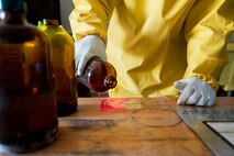 Airman 1st Class Courtney Harrah, 5th Maintenance Squadron non-destructive inspection apprentice, performs a Cracked Chrome Panel test for the stationary fluorescent penetrant inspection line.  The purpose of this test is to evaluate our in use inspection materials against a control set. (U.S. Air Force photo/Senior Airman Brittany Y. Bateman)
